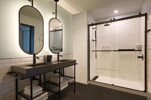 a bathroom with a sink and a shower at Moxy Virginia Beach Oceanfront in Virginia Beach