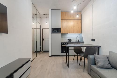 a kitchen and living room with a table and chairs at 26305 New smart studio in RC Manhattan City in Kyiv