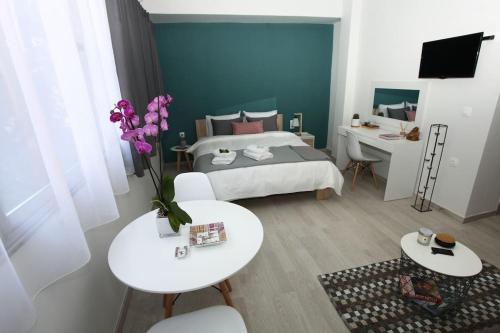 a bedroom with a bed and a table and chairs at Old Town Hall Suites and Apartments in Athens