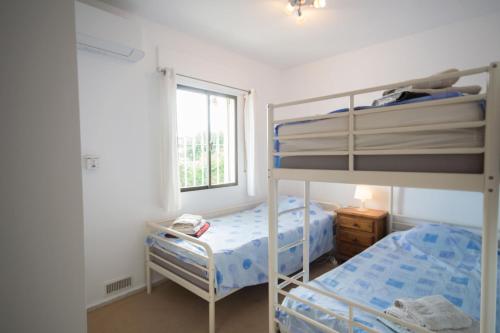 1 dormitorio con 2 literas y ventana en Villa Janina, en Fuengirola