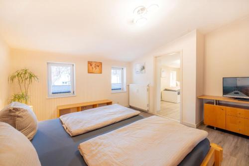 a bedroom with a bed and a tv in it at Ferienapartments Stralsund in Stralsund