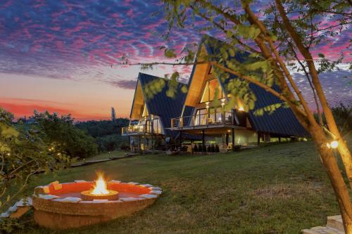 a fire pit in front of a house at Arta Chalet in Ceptura de Jos