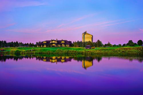 a building next to a lake in front of a building at Grand Traverse Resort and Spa in Traverse City