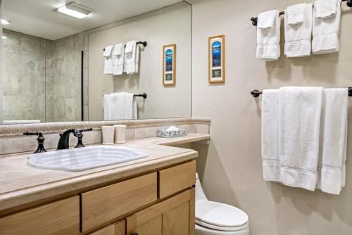 a bathroom with a sink and a toilet and a mirror at Vail Antlers 2 Bedroom Condo in Vail