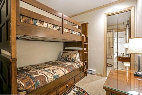 a bedroom with two bunk beds and a mirror at Vail Antlers 2 Bedroom Condo in Vail