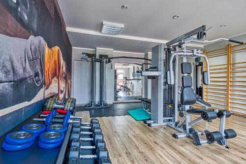 a gym with a bunch of equipment in a room at St Lukas Medical & SPA in Świeradów-Zdrój