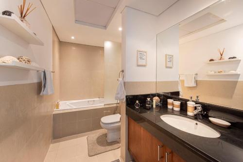 a bathroom with a sink and a toilet at Nasma Luxury Stays - Charming And Fancy Studio In The Heart of Dubai in Dubai