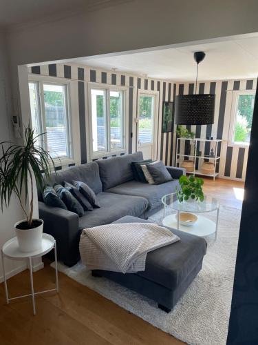 a living room with a couch and a table at Trevligt hus i mysiga Mollösund Tången in Mollösund