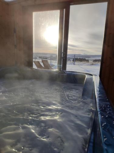 a hot tub in a room with a window at Ben Aigan in Keith