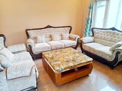 a living room with two couches and a coffee table at Virat Resorts, Sariska Rajasthan in Bairāt