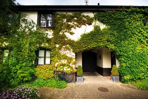 a house covered in ivy with a door at The Groes Inn in Conwy