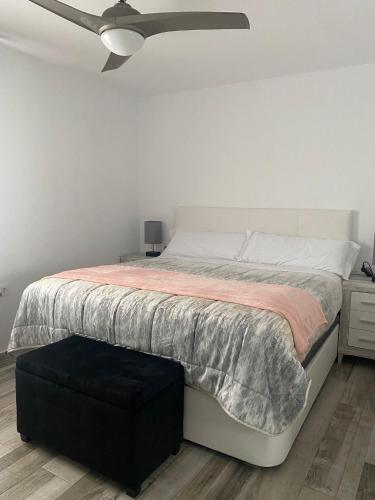 a bedroom with a bed with a ceiling fan at Tarifabeach in Tarifa