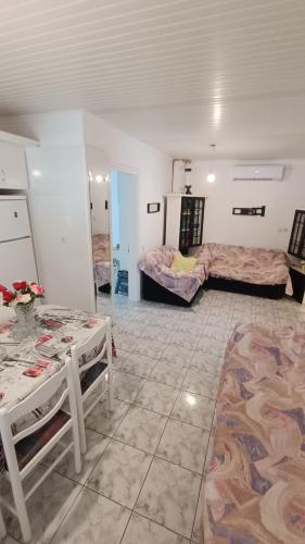 a room with two beds and two tables in it at Vasiliki's guest house in Vergia
