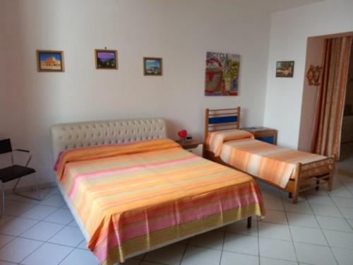 a bedroom with two beds in a room at Sole, Mare e Relax a Matino La Tua Oasi Salentina in Matino