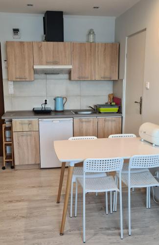 a kitchen with a table and chairs in a room at Apartament Stegna in Stegna