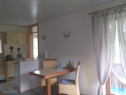 a kitchen with a wooden table and a table and chairs at Pension Schatzkisterl in Zwiesel
