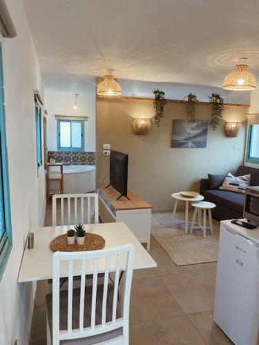 a living room with a couch and a table at בקתה במטע מושב אליעד in Eli Ad
