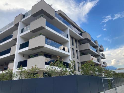 a white apartment building with plants on the facade at Green Life in Riva del Garda