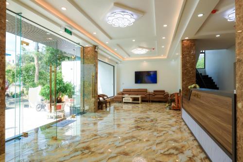 a lobby with glass doors and a living room at Havana Con Dao Hotel in Con Dao