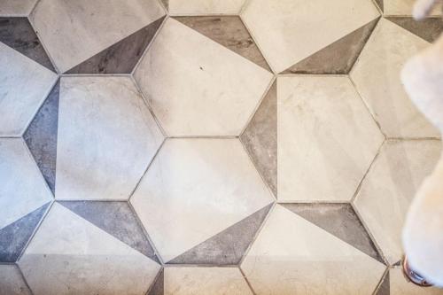 a hexagonal tile floor in a kitchen at The Old Shop, Studio Hideout, Stoke Fleming in Stoke Fleming