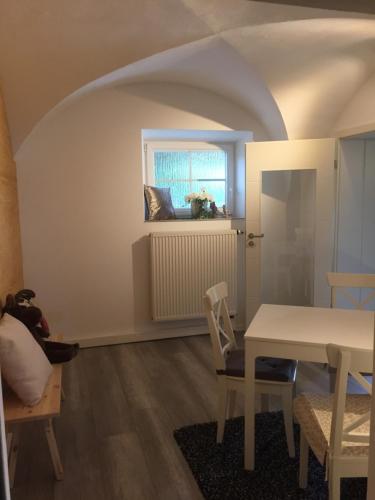 a dining room with a table and a window at Apartmentvermietung Ingrid Bolkart - Landleben 6 in Illertissen