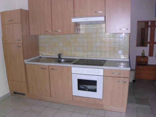 a kitchen with a sink and a stove top oven at Apartment Sun in Novalja