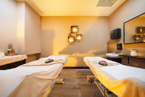 a hospital room with two beds and a sink at Bull Vital Suites & Spa Boutique Hotel - Only Adults in Playa del Ingles