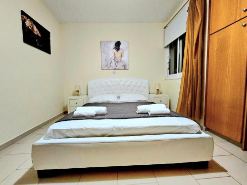 a bedroom with a large bed in a room at Spacious Villa with Private Pool in Paphos City