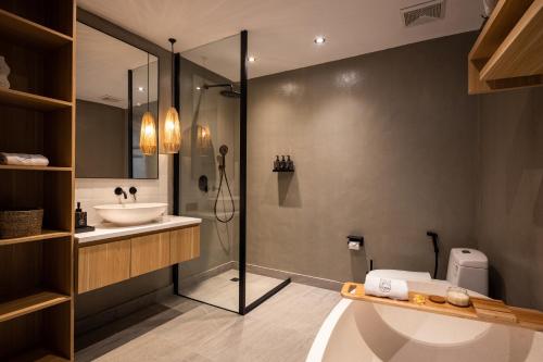 a bathroom with a sink and a shower and a toilet at Ananda Villa by Betterplace in Jimbaran
