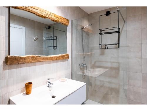 a bathroom with a sink and a shower with a mirror at Casa Tiare in La Oliva