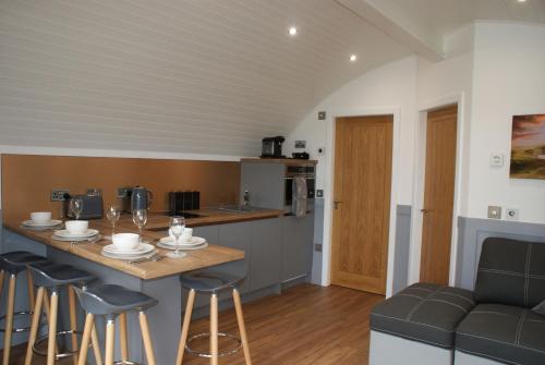 a kitchen and living room with a table and chairs at Knockan in Keith
