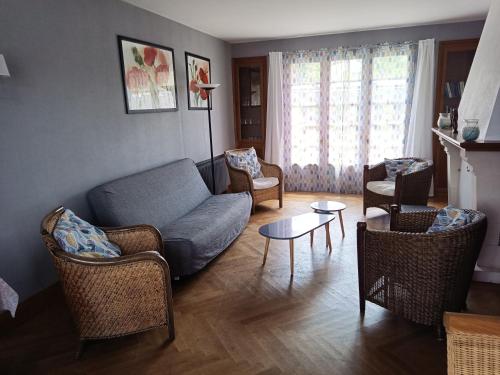 un salon avec un canapé, des chaises et une table dans l'établissement La Tribu de Beauval 6ch grand terrain et parking privé, à Saint-Aignan