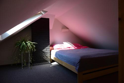 a bedroom with a bed and a pink ceiling at Leśny kącik 