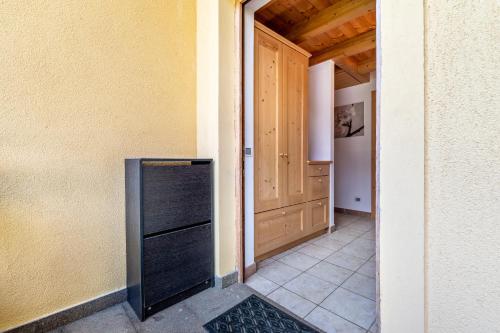 a kitchen with a black refrigerator next to a door at Appartamento Davide in Pera