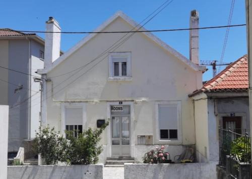 a white house with a door in a street at Stay in Sintra in Sintra