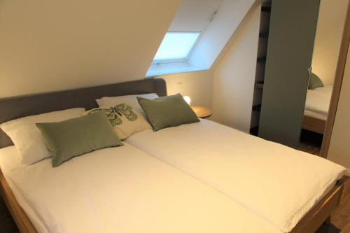 a bed with two pillows on it in a room at Ferienhaus Alwine in Jork