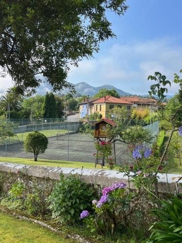 a park with a tennis court in the background at Los Cuetos in Santianes