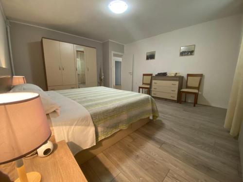 a bedroom with a bed and a dresser and a desk at Klementina in Mali Lošinj