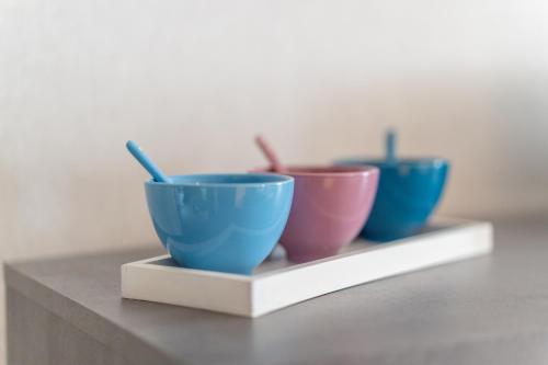 three bowls are sitting on a shelf at Maison Florentine in Gunstett