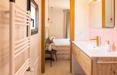 a bathroom with a sink and a tub at Can Candiu Establecimiento de 2 casas enteras in Vall-Llobrega