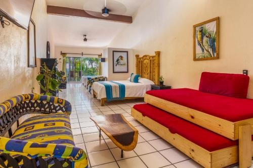 a hotel room with two beds and a couch at Casa María Resort in Bucerías