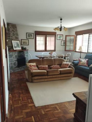 a living room with a couch and a fireplace at Casa La Bolera in Carreña de Cabrales 