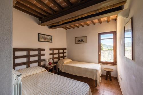 Ένα ή περισσότερα κρεβάτια σε δωμάτιο στο Agriturismo Podere Binacco