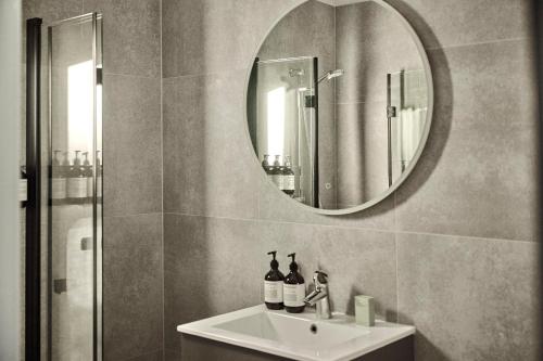 a bathroom with a sink and a mirror at Hotel Filip in Oslo