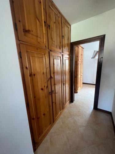 a hallway with wooden cabinets in a house at Casa Vacanza Regina in Roccaraso