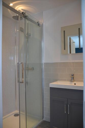 a bathroom with a shower and a sink at The Thorold in Marston