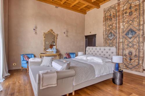 a bedroom with a bed and a large tapestry on the wall at Relais Le Due Matote in Bossolasco