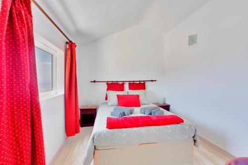 1 dormitorio con 1 cama con almohadas rojas en La Graciosa - Casa Marosenia, en Güime