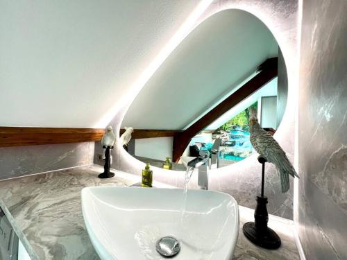 a white sink in a bathroom with a mirror at Natural Suite - Proche Gare - 4P in Belfort