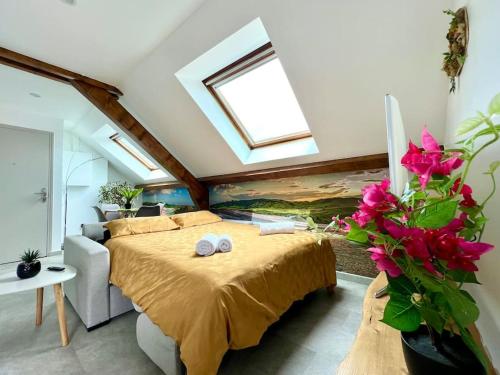 a bedroom with a bed with two pillows on it at Natural Suite - Proche Gare - 4P in Belfort